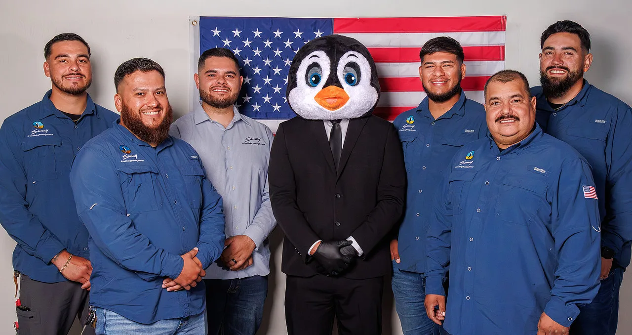 The Sunny Air Conditioning, Plumbing & Electrical team with the Sunny penguin mascot